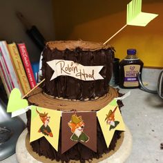 there is a chocolate cake with decorations on the top and banner around it that says robin's head