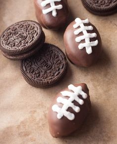 chocolate covered oreos with white frosting and footballs on the top are ready to be eaten