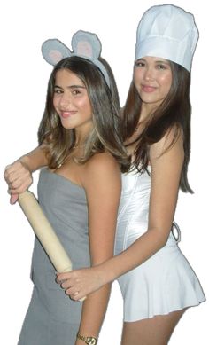 two girls dressed up in bunny ears holding a baseball bat