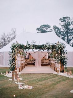 an outdoor wedding setup with white flowers and greenery