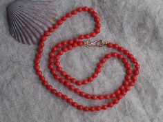 These high grade all natural Sardinian coral beads have a gorgeous, rich tomato red color. They are an amazing work of nature from the Mediterranean Sea, blemish-free surface and lovely round shape, 100% natural beauty.  Their color is natural, these beads have not been dyed! The beads are 4mm rounds hand knotted on bright red silk, paired with 14k gold saucer beads and handmade classic hook clasp, also 14k gold.  These beads look great worn on their own, or layered with your other favorite neck Red Coral Round Beads Single Strand, Single Strand Red Coral Round Beads, Single Strand Red Coral Beads, Single Strand Round Red Coral Beads, Red Coral Necklace, Coral Beads Necklace, Coral Ring, Coral Necklace, Coral Jewelry