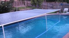 an above ground swimming pool with a cover over the bottom and some water around it