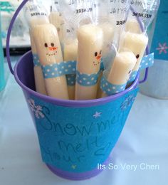 there are many candles in the cup with snowmen on them and wrapped in plastic wrappers