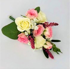 a bouquet of flowers on a white surface