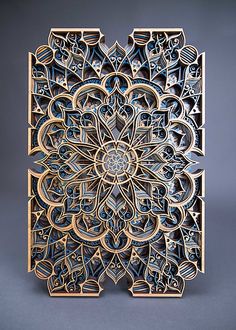 an intricately designed wooden block with blue and white designs