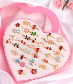 "A pretty pink heart shaped box brimming with 36 adorable rings! At only 70 cents per ring, imagine greeting your little party guests at the door with their choice of rings to wear! Each box contains an assortment of gold-toned, adjustable rings that feature colorful enameled butterflies, cats, owls, bunnies, stars, bows, unicorns, cupcakes, cherries, hearts, flowers, and much much more! Some rings also have crystals and pearls attached.  Each ring is approximately size 4 1/2 and can be adjusted Girls Slumber Party, Kids Accessories Jewelry, Heart Shape Box, Kids Rings, Pink Plastic, Rings For Girls, Fashion Toys, Party Guests