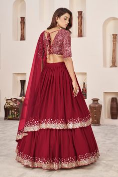 This is a 3-piece set. The set consists of blouse with sequins & zari detailing, v neck teamed with flared lehenga and a dupatta. No of piece - 3 piece Color- Red Fabric-Georgette Dupatta Fabric - Soft Net Blouse Sleeves-Above Elbow Sleeves Neck-V Neck Lehenga length: Floor Length Washing instructions: Dry Clean Work- Zari & Sequins Print Detailing. Flared lehenga Comes with Dupatta Customizations: available. Please add your measurements in the 'order notes' box during checkout. Model with height is wearing size Small. Gopi Dress, Stylish Lehenga, Flared Lehenga, Engagement Gown, Lehenga Crop Top, Georgette Material, Georgette Lehenga, Lehenga Choli Wedding, Party Wear Lehenga Choli