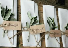 napkins tied with twine and green leaves are wrapped in white paper that says smellly