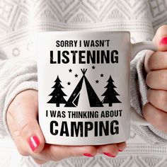 a woman holding a coffee mug with the words, sorry i was listening i was thinking about camping