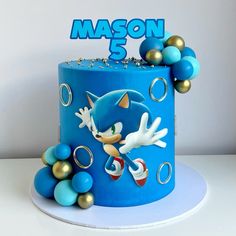 a sonic the hedgehog themed birthday cake with balloons and decorations on top that says mason 5