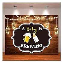 a baby is brewing sign hanging on the wall in a room with lights and mason jars