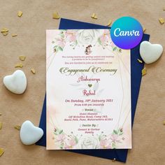 a wedding card with flowers and hearts on it next to some confetti rocks