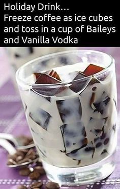 a glass filled with ice cream and toppings on top of a purple table cloth