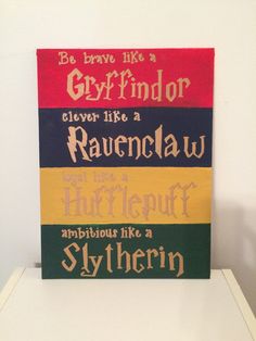 a sign that is on top of a white table in front of a wall with the words, be brave like a gryffindor cleverer like a ravenclaw