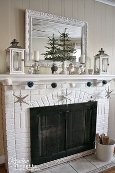 a fireplace decorated for christmas with candles, ornaments and a mirror on top of it