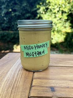 a mason jar with a note on it that says miso honey mustard