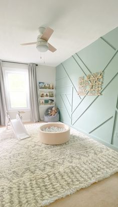 a baby's room with a white rug and blue walls