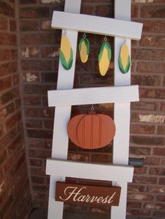 a white wooden sign sitting next to a brick wall