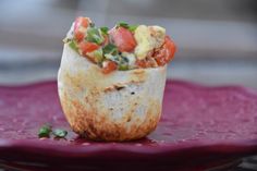 a burrito sitting on top of a purple plate