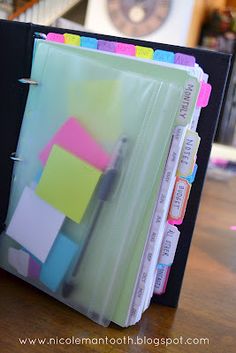 a binder with several folders in it sitting on a table