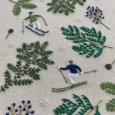 an embroidered pattern with skiers and trees