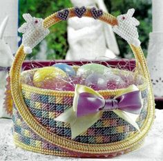 a basket that has been decorated with beads and bows on the handle is sitting on a table