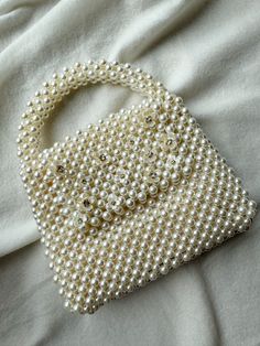 This Beautiful Bag is handmade of Pearls decorated with Crystal blossom. It can be closed with a magnetic bottom and has an inner lining. Chic Beaded Wedding Bags, Pearl Beaded Wedding Bags, Wedding Handheld Bags With Pearl Handle, Elegant Handheld Pearl Bag, Wedding Shoulder Bag With Pearl Handle, Rectangular, Pearl Bags, Hand Beaded Bag, Wedding Handbag, Bead Bag