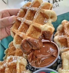 the waffles are being dipped with chocolate