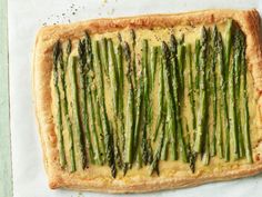 asparagus and cheese tart on top of a piece of parchmented paper