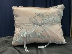 a white pillow with a bow on it