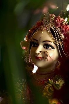 a close up of a mask with flowers in the background