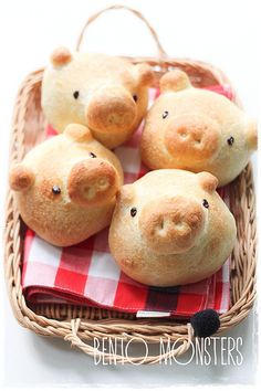 four pigs in a basket with red and white checkered table cloth