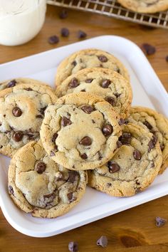 chocolate chip cookies on a plate next to milk