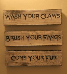 three wooden signs that say wash your claws, brush your fangs and comb your fur