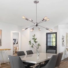 a white dining room table with grey chairs