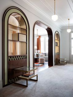 a living room filled with furniture and arched doorways