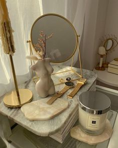 a table topped with a mirror and other items