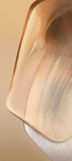 a close up view of a bowl on a white table top with brown and tan colors