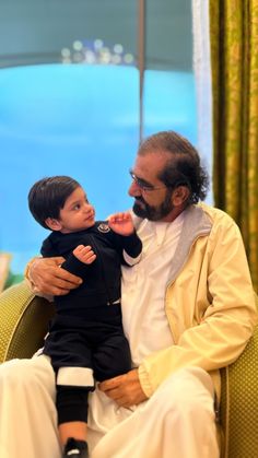 a man holding a small child in his lap