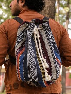 Get ready to hit the road with the Banjara Backpack! Made from durable cotton jacquard fabric, this thick and sturdy hippie bag is the perfect travel companion. With an adjustable belt and drawstring opening, you can easily access your belongings in the spacious main compartment, and keep small items secure in the zipper compartment inside. Stay stylish and ready for adventure with the Banjara Backpack! Hippie Cotton Shoulder Bag For Travel, Bohemian Cotton Shoulder Bag For Travel, Bohemian Backpack With Adjustable Strap For Festivals, Hippie Bags, Hit The Road, Adjustable Belt, Jacquard Fabric, Travel Companion, Small Items