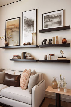 Contemporary living room featuring a wall with framed artistic sketches and landscape paintings. Floating Shelves And Picture Wall, Modern Floating Shelves Living Room, Awkward Corner Space Living Room, Shelves Over Couch, Shelves Above Couch, House Refurbishment, Above Couch Decor, Couch Wall Decor, Above The Couch