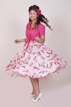 a woman in pink shirt and skirt posing for the camera