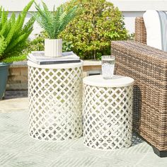 two wicker stools sitting next to each other on a patio