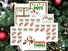 christmas themed printables and stickers for the holiday season are displayed in front of a tree