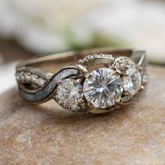 an engagement ring on top of a rock