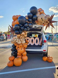 a car with balloons and pumpkins on the back