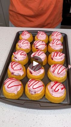 there are many doughnuts with pink icing on them