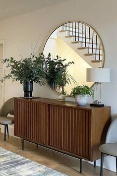 a living room with a large mirror on the wall