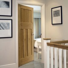 an open door leading to a bedroom with pictures on the wall