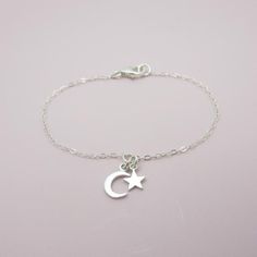 ALL SOLID STERLING SILVER PARTS - A QUALITY BRACELETThis high quality bracelet is made using adorable sterling silver charms in a moon and star shape.  A sturdy sterling silver chain and lobster clasp make this a durable bracelet. Comes in a gift box perfect for gift giving. Moon charm measures approximately 3/8 inch tall and the star 1/4 inch tall. SIZING - IMPORTANT: To determine bracelet size, measure snugly around your wrist and add 1/2 inch to get your bracelet size. Do NOT order in your ex Sterling Silver Celestial Bracelet With Moon Charm, Silver Celestial Bracelets For Gift, Sterling Silver Moon Charm Bracelet, Sterling Silver Bracelet With Moon Charm, Celestial Sterling Silver Bracelets, Silver Celestial Bracelet With Star Charm, Celestial Silver Bracelet With Star Charm, Sterling Silver Bracelets With Moon Charm, Silver Minimalist Moon Bracelet